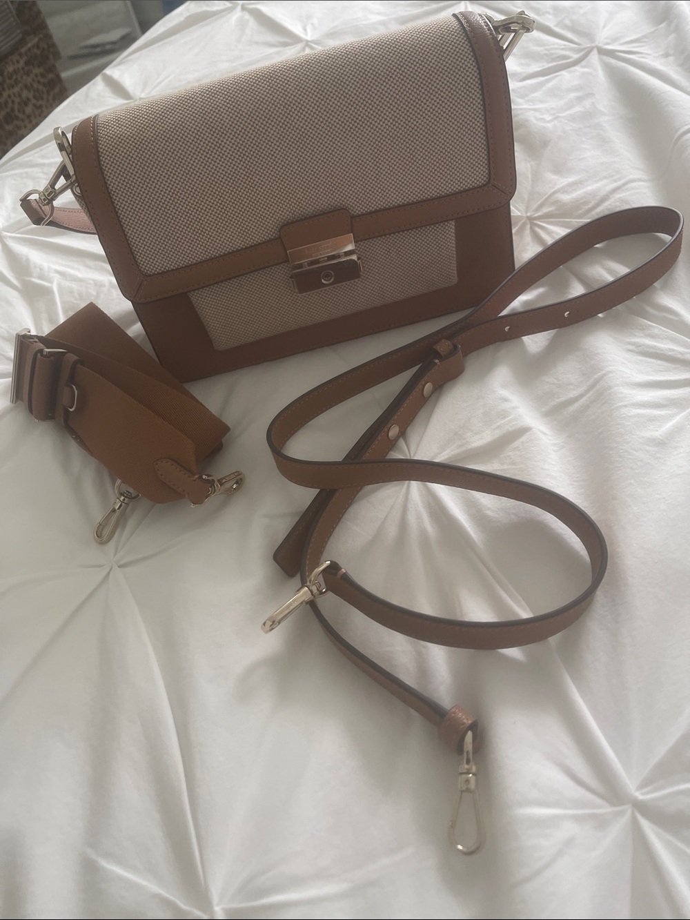 Kate Spade Voyage Canvas Medium Shoulder Bag, which features a beige canvas body